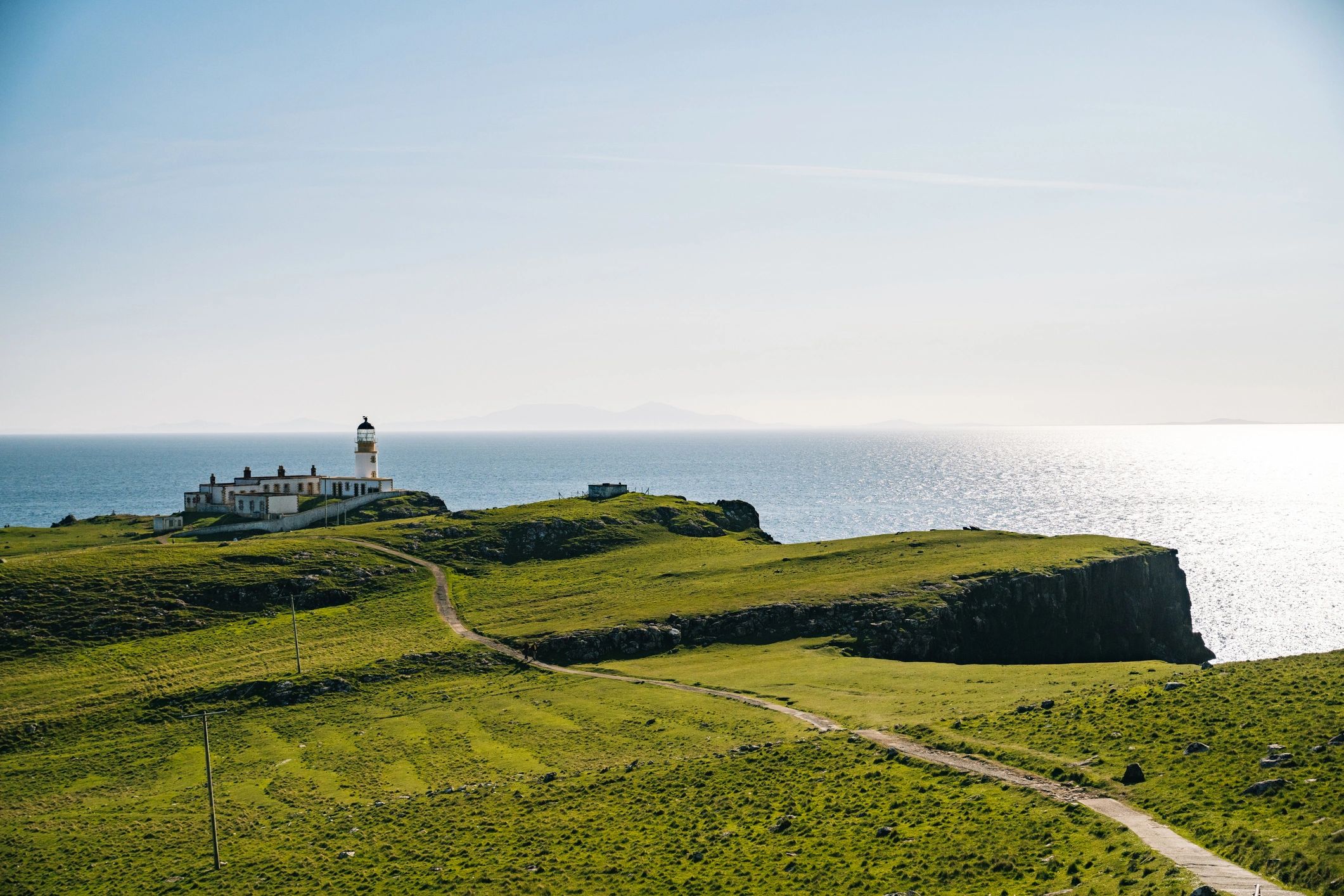 Calm coastal headland and sea under morning light